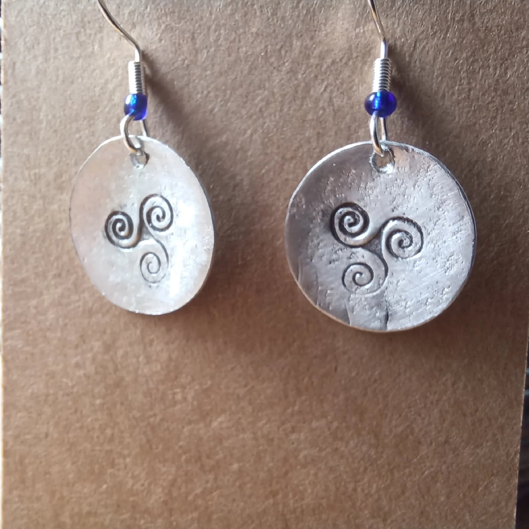 handmade hammered and stamped triskele earrings with silver hooks