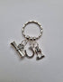 Graduation gift keyring with 3 charms; a scroll, a lucky horseshoe and two goblets, and the word ‘Cheers’. A super gift for a graduate.