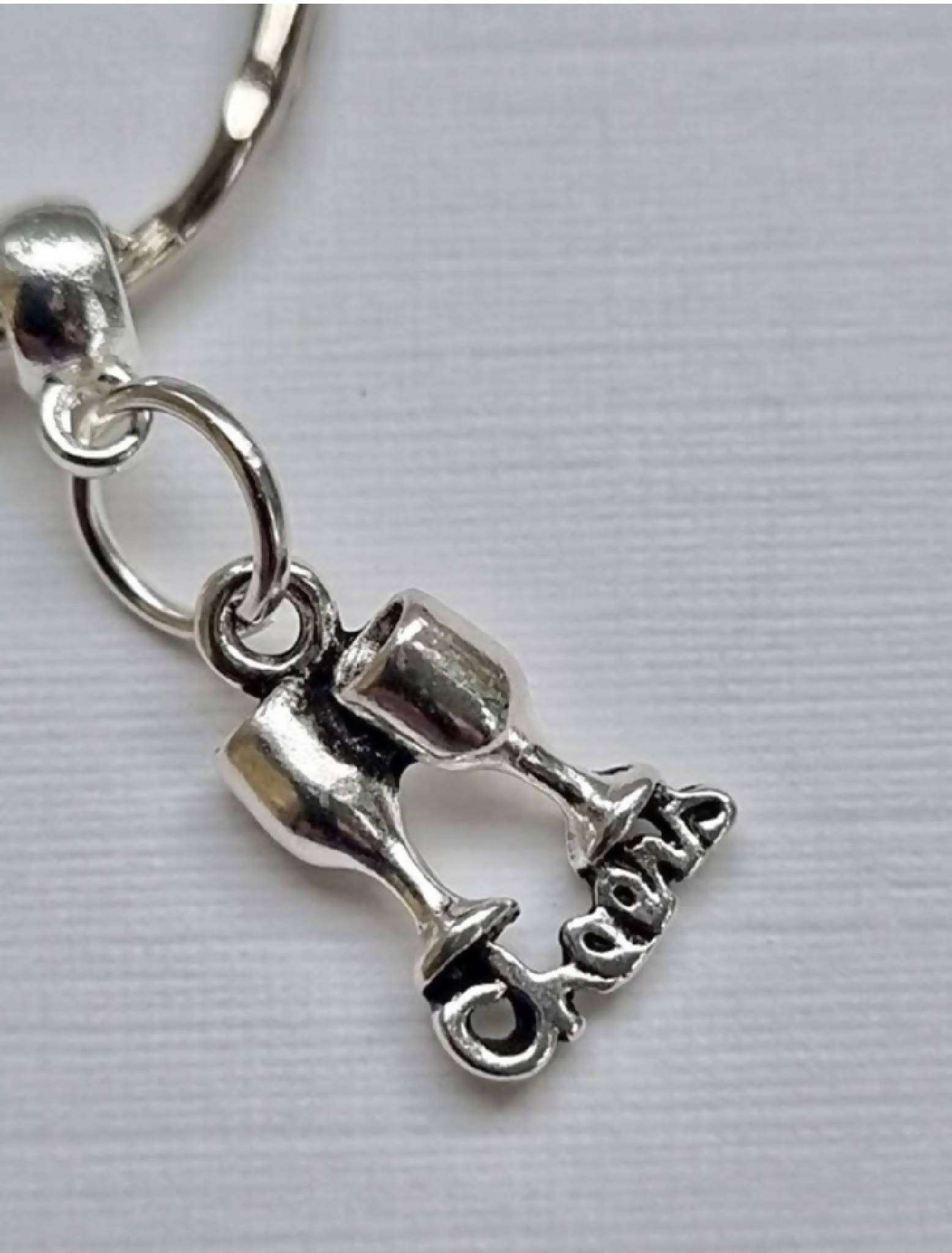 Graduation gift keyring with 3 charms; a scroll, a lucky horseshoe and two goblets, and the word ‘Cheers’. A super gift for a graduate.